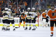 Boston Bruins' Matt Grzelcyk (48) celebrates with teammates after scoring a goal during the second period of an NHL hockey game against the Philadelphia Flyers, Tuesday, March 10, 2020, in Philadelphia. (AP Photo/Matt Slocum)