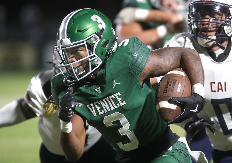 Venice running back Jamarice Wilder (3) rushes for a huge gain against the defense of Clearwater AI during Friday night football action in Venice. MATT HOUSTON/HERALD-TRIBUNE