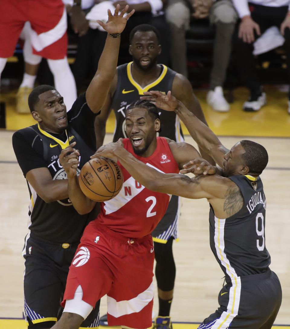 Toronto Raptors forward Kawhi Leonard #2 is defended by Golden State Warriors players Kevon Looney #5, Andre Iguodala #9 and Draymond Green #23 during the second half of the NBA Finals basketball Game 6 between the Toronto Raptors and the Golden State Warriors at Oracle Arena, in Oakland, California. (Photo by EPA/MONICA M DAVEY)