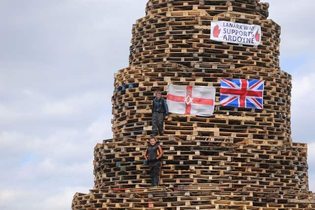 Bonfire builders in the New Mosley area of Belfast