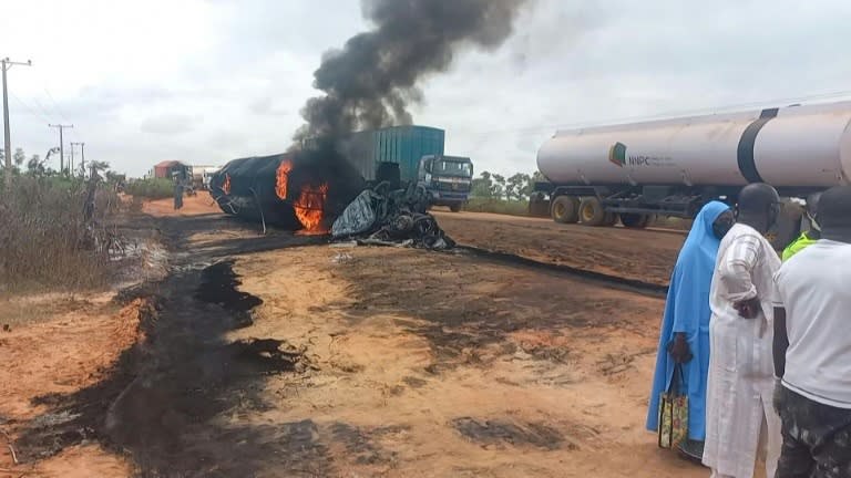 A Niger State Emergency Management Agency image shows flames and smoke billowing from the tanker after it collided with a truck carrying passengers and cattle (-)