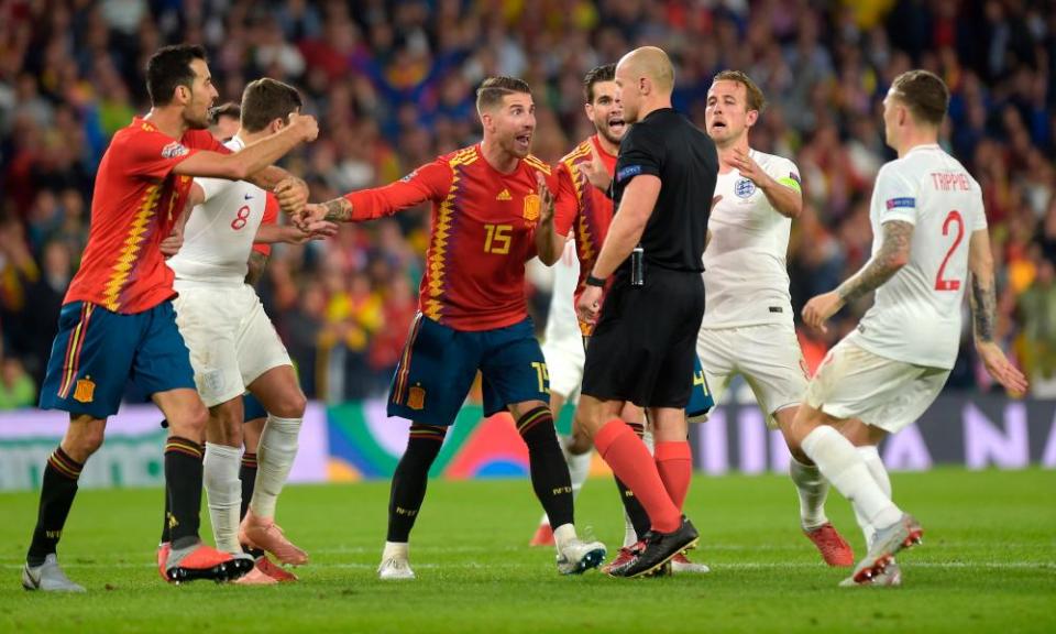 Sergio Ramos (centre) argues with Szymon Marciniak after the Polish referee decided not to award Spain a penalty in the second half.