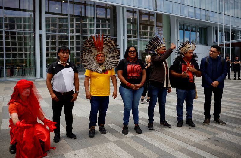 A coalition of environmental activists and Indigenous groups from Brazil protests outside the courthouse in Paris