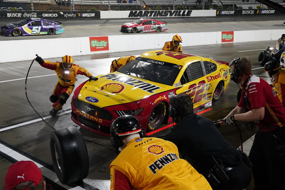 Joey Logano (22) makes a pit stop before rain halted the NASCAR Cup Series auto race at Martinsville Speedway in Martinsville, Va., Saturday, April 10, 2021. (AP Photo/Steve Helber)