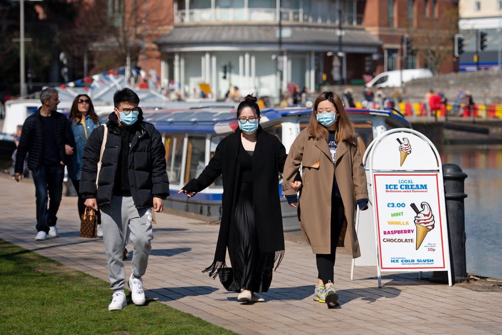 People wearing protective face masks walking in Stratford-upon-Avon in Warwickshire (PA Wire)