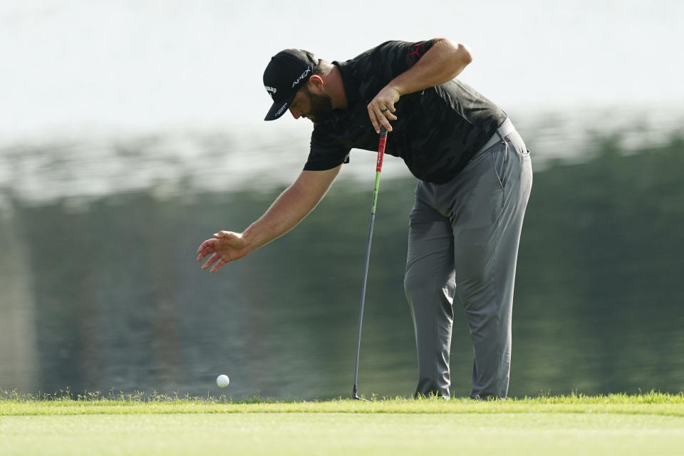 Jon Rahm, of Spain, takes a drop on the eight fairway after his drive went into the lake during the third round of the Tour Championship golf tournament at East Lake Golf Club Saturday, Aug. 27, 2022, in Atlanta. (AP Photo/John Bazemore)