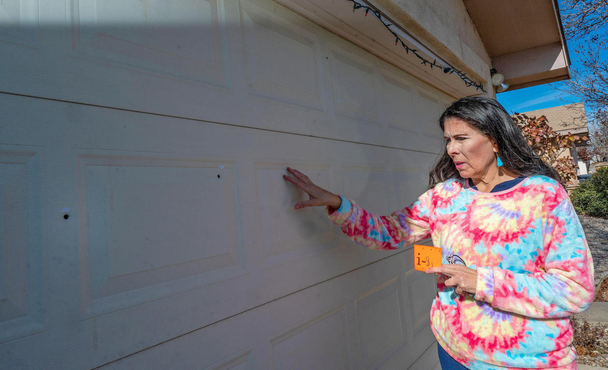 State Sen. Linda Lopez, D-Albuquerque, shows bullet holes in her garage door on Jan. 5, 2023, after her home was shot at. (Adolphe Pierre / Albuquerque Journal via Alamy)