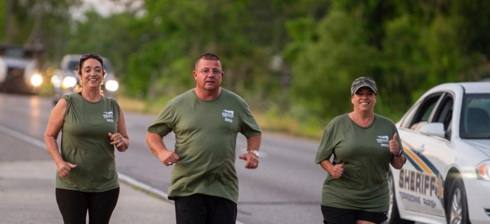 Terrebonne Parish Sheriff Tim Soignet runs with his officers to Troop C headquarters in Gray on Friday during the Torch Run to raise money for the Special Olympics.
