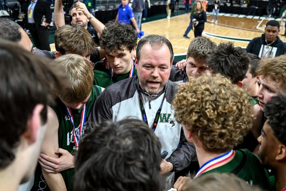Williamston's head coach Tom Lewis, center, talks with the team after beating Grand Rapids Catholic Central 68-65 to win the Division 2 title on Saturday, March 26, 2022, at the Breslin Center in East Lansing.