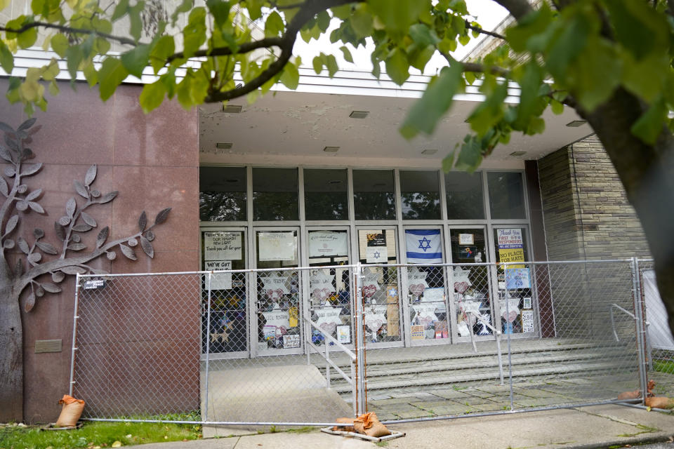 This photo from Oct. 16, 2021, shows an entrance to the the dormant landmark Tree of Life synagogue that has many of the memorials that were placed outside the building in Pittsburgh's Squirrel Hill neighborhood where 11 people were killed in America's deadliest antisemitic attack on Oct. 27, 2018. Renowned architect Daniel Libeskind is among those working to transform the site to share space with the Holocaust Center of Pittsburgh with the goal to create a solemn memorial as well as a place of regular activity is underway as the date marking the third year since the shootings approaches. (AP Photo/Keith Srakocic)