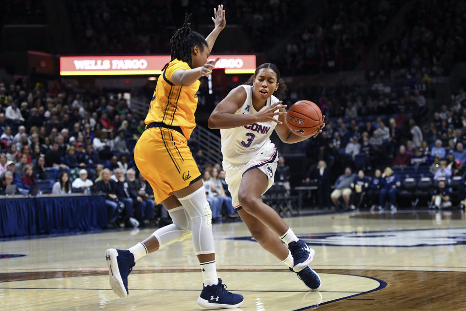 FILE - In this Nov. 10, 2019, file photo, Connecticut's Megan Walker (3) drives around California's Jaelyn Brown (33) during the first half of an NCAA college basketball game in Storrs, Conn. Walker was selected to The Associated Press women's All-America first team, Thursday, March 19, 2020. Walker gave UConn a first-teamer for the seventh consecutive season. (AP Photo/Stephen Dunn, Fle)