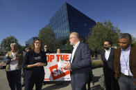 Maarten Botterman, center, chairman of the Internet Corporation for Assigned Names and Numbers, accepts a petition of more than 35,000 signatures and about 700 companies from Amy Sample Ward, CEO of the Nonprofit Technology Enterprise Network, during a protest Friday, Jan. 24, 2020, in Los Angeles outside ICANN's headquarters which is the regulatory body for domain names. The company that controls the dot-org online universe is putting the registry of domain names up for sale, and the nonprofits that often use the suffix in their websites are raising concerns about the move. ICANN is meeting this weekend and is expected to rule by mid-February on plans by private-equity firm Ethos Capital to buy the Public Interest Registry for $1.1 billion. (AP Photo/Mark J. Terrill)