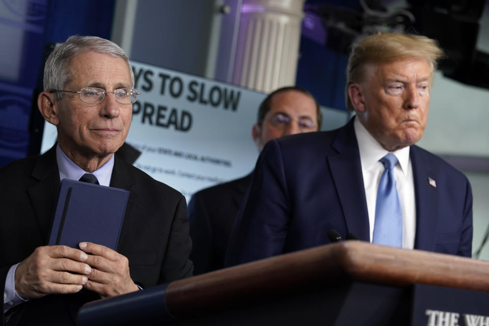 President Donald Trump and Dr. Anthony Fauci, director of the National Institute of Allergy and Infectious Diseases, listen during a press briefing with the coronavirus task force, in the Brady press briefing room at the White House, Monday, March 16, 2020, in Washington. (AP Photo/Evan Vucci)