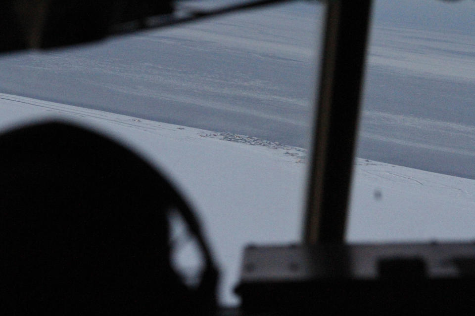 FILE - This Dec. 6, 2014, file photo shows the community of Shishmaref, Alaska, as seen from the cockpit of an approaching C130 military transport plane. Attorneys for 12 young Alaskans who sued over state climate change policy will argue their case before Alaska Supreme Court justices on Wednesday, Oct. 9, 2019. The lawsuit says state policy that promotes fossil fuels violates the constitutional right of young Alaskans to a safe climate. (AP Photo/Mark Thiessen, File)