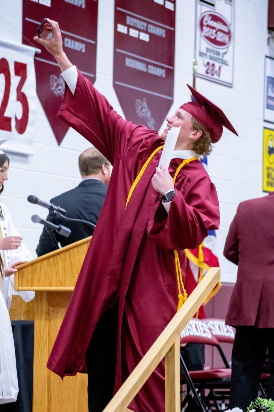 A graduate grabs a quick selfie on stage after receiving his diploma at John Glenn's graduation on Friday, May 6. For more photos visit www.daily-jeff.com.