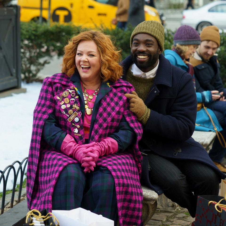 a man and woman sitting on a bench