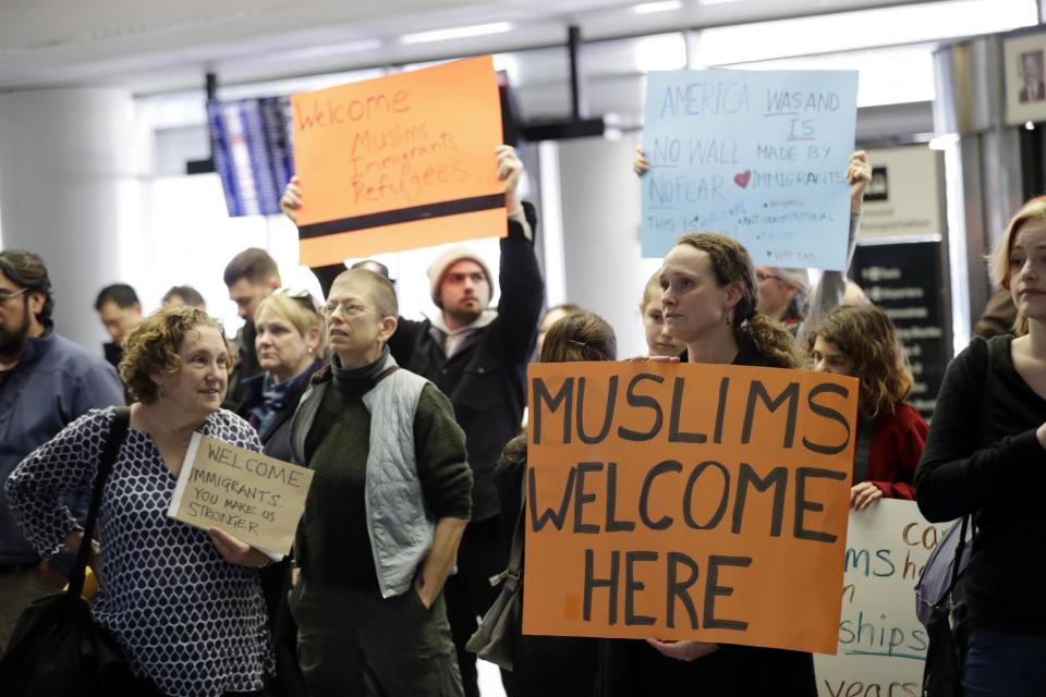 Protesters holds signs at San Francisco International Airport to denounce President Donald Trump's executive order that bars citizens of seven predominantly Muslim-majority countries from entering the U.S., Monday, Jan. 30, 2017, in San Francisco. (AP Photo/Marcio Jose Sanchez)