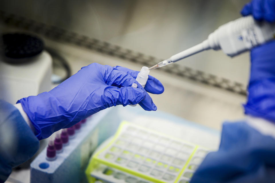 FILE - A laboratory technician prepares COVID-19 patient samples for semi-automatic testing at Northwell Health Labs, March 11, 2020, in Lake Success, N.Y. Republicans' faith in science is falling as Democrats rely on it even more with a trust gap in science and medicine widening substantially during the COVID-19 pandemic, new survey data shows. It’s the largest gap in nearly five decades of polling by the General Social Survey, a widely respected trend survey conducted by NORC at the University of Chicago that has been measuring confidence in institutions since 1972. (AP Photo/John Minchillo, File)