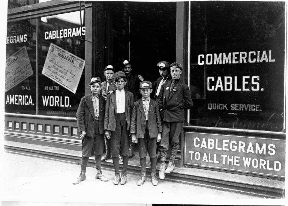 Messenger boys stand outside a telegraph office in Indianapolis, Indiana, in August 1908.