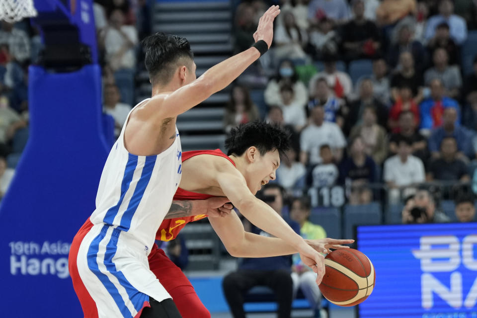 China's guard Hu Mingxuan (3), right, is fouled by Taiwan's forward Liu Cheng (5) during the men's bronze medal basketball match between China and Taiwan at the 19th Asian Games in Hangzhou, China, Friday, Oct. 6, 2023. (AP Photo/Lee Jin-man)