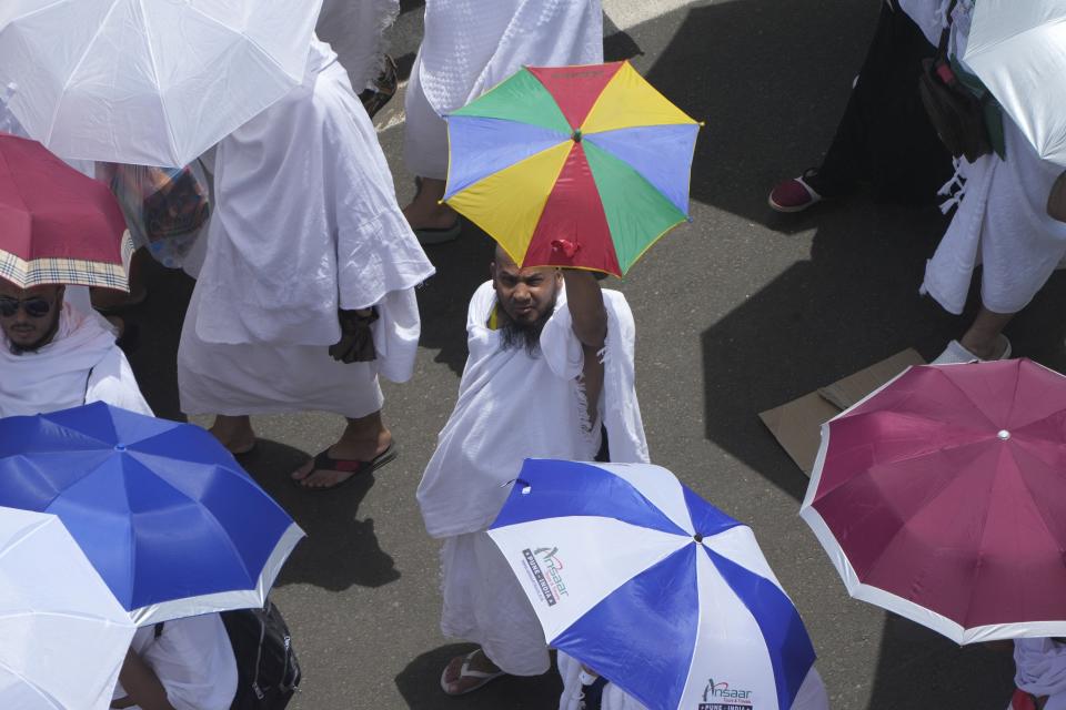 Muslim pilgrims move on their way to perform Friday Prayers at Namira Mosque in Arafat, on the second day of the annual hajj pilgrimage, near the holy city of Mecca, Saudi Arabia, Friday, July 8, 2022. (AP Photo/Amr Nabil)