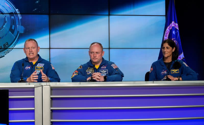 Astronauts Butch Wilmore, Mike Fincke and Sunny Wiiliams attend a news conference at the Kennedy Space Center 