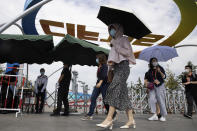 Visitors wearing mask to protect from the coronavirus walks past a venue for the China International Fair for Trade in Services (CIFTIS) to be held in Beijing on Friday, Sept. 4, 2020. As China recovers from the COVID-19 pandemic, business as usual is picking back up with the holding of the China International Fair for Trade in Services. Nearly 2,000 Chinese and foreign enterprises will participate and showcase their newest technology in public health and digital technology (AP Photo/Ng Han Guan)