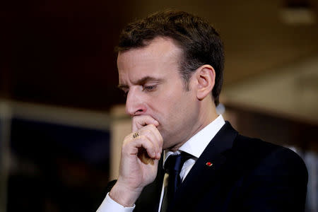 French President Emmanuel Macron reacts during a visit at a mediatheque in Les Mureaux, Paris suburb, France, February 20, 2018. REUTERS/Ludovic Marin/Pool