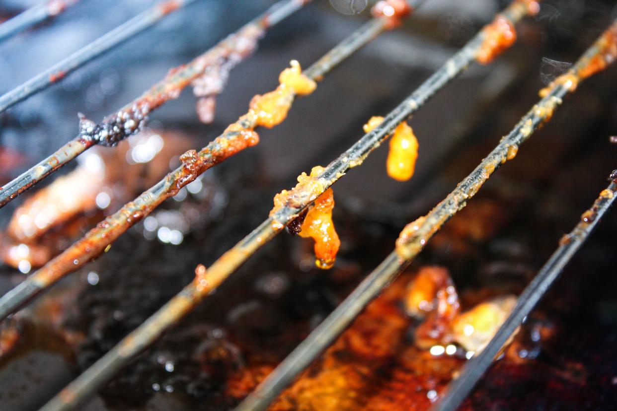 Dirty greasy barbecue grill. Fat and meat residues on the wire shelf after cooking.