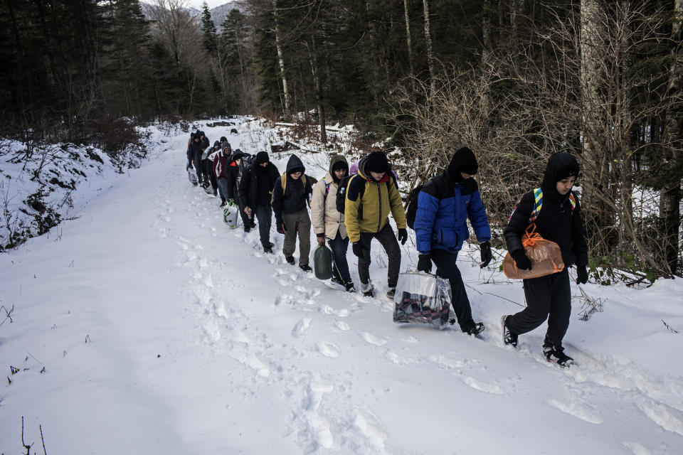 A group of Egyptian migrants walk through the snow in a mountain area believed to be littered with landmines planted during the Bosnian war, as they attempt to cross the border into Croatia near Bihac, northwest Bosnia on Dec. 15, 2019. (Photo: Manu Brabo/AP)   