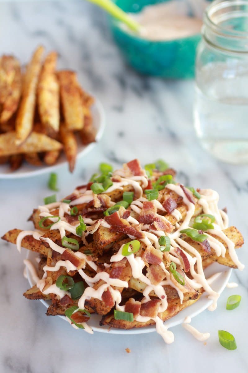 <strong>Get the <a href="http://www.halfbakedharvest.com/double-baked-fries-with-garlic-cheese-sauce-and-bacon/" target="_blank">Double-Baked Fries with Garlic Cheese Sauce and Bacon recipe</a> from Half Baked Harvest</strong>