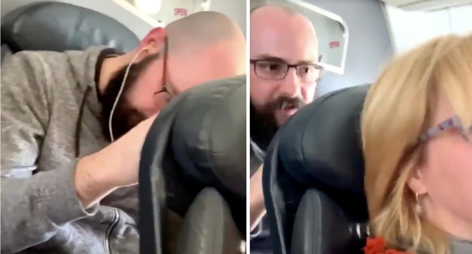 A screenshot from a video shows a man pushing a woman's seat on an American Airlines flight. 