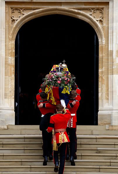 WINDSOR, ENGLAND - SEPTEMBER 19: Pall bearers carry the coffin of Queen Elizabeth II with the Imperial State Crown resting on top into St. George's Chapel on September 19, 2022 in Windsor, England. The committal service at St George's Chapel, Windsor Castle, took place following the state funeral at Westminster Abbey. A private burial in The King George VI Memorial Chapel followed. Queen Elizabeth II died at Balmoral Castle in Scotland on September 8, 2022, and is succeeded by her eldest son, King Charles III. (Photo by Jeff J Mitchell/Getty Images)