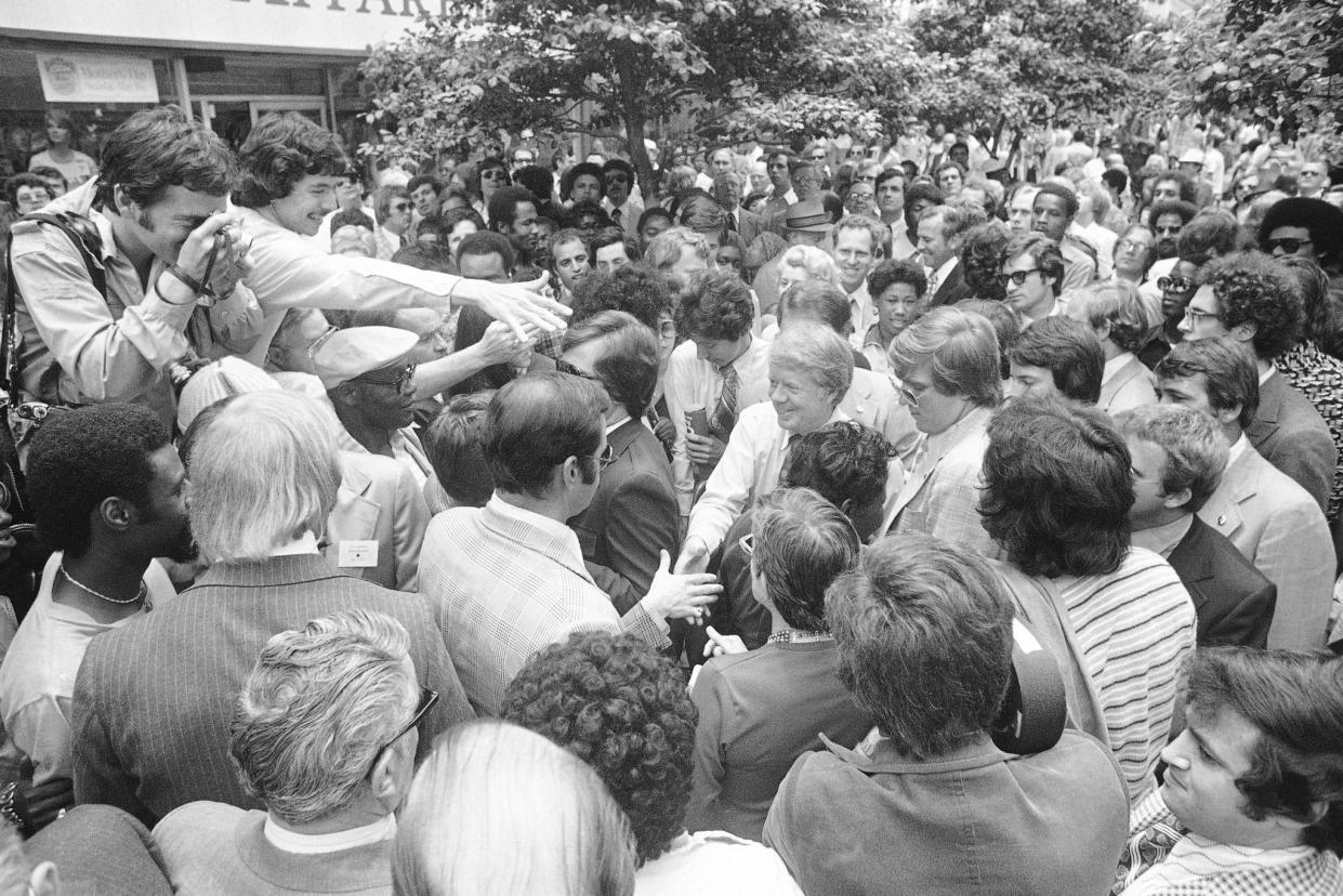 Former Georgia Gov. Jimmy Carter wades through a crowd of two thousand Marylanders on May 7, 1976, in Baltimore, while campaigning for the Democratic presidential primary on May 18. Former Gov. Carter addressed the group and then departed for Detroit.
