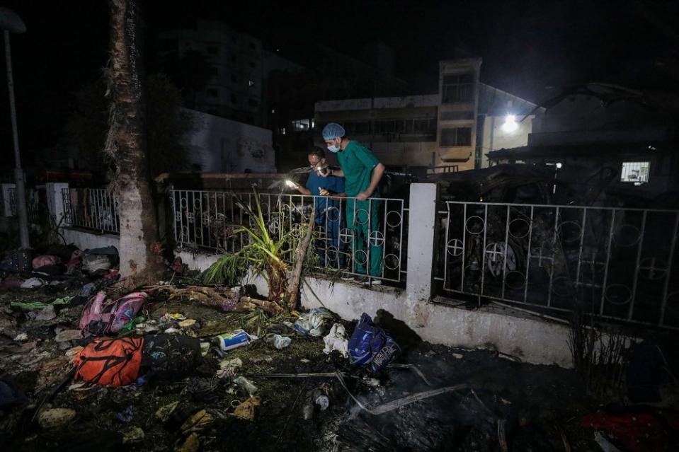 Palestinian doctors search for bodies and survivors in the rubble of Al Ahli hospital after an air strike in Gaza City, on Oct. 17.<span class="copyright">Mohammed Saber—EPA-EFE/Shutterstock</span>