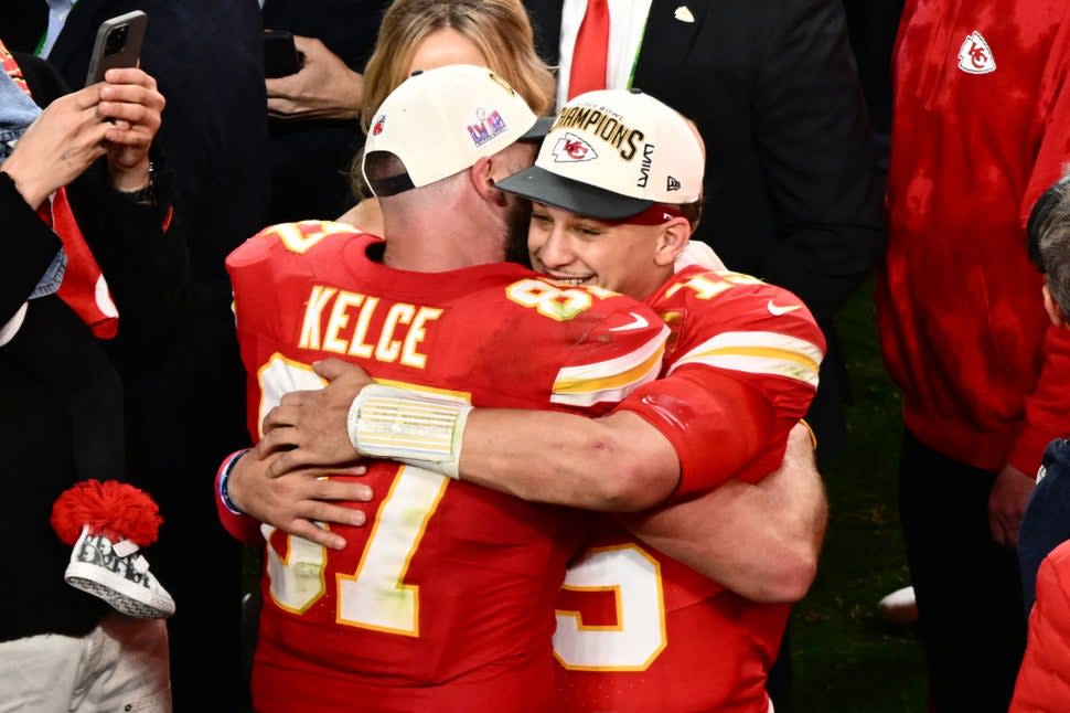 Kansas City Chiefs' tight end #87 Travis Kelce and Kansas City Chiefs' quarterback #15 Patrick Mahomes hug after winning Super Bowl LVIII against the San Francisco 49ers at Allegiant Stadium in Las Vegas, Nevada, February 11, 2024.