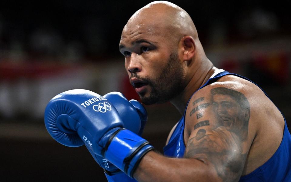 Britain's Frazer Clarke fights Ukraine's Tsotne Rogava during their men's super heavy  - AFP