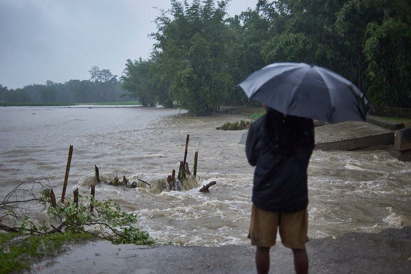 A washed away road by floods in a village in Assam.