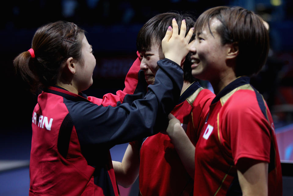 LONDON, ENGLAND - AUGUST 05: Ai Fukuhara (L), Kasumi Ishikawa (C) and Sayaka Hirano (R) of Japan celebrate after winning Women's Team Table Tennis semifinal match against team of Singapore on Day 9 of the London 2012 Olympic Games at ExCeL on August 5, 2012 in London, England. (Photo by Feng Li/Getty Images)