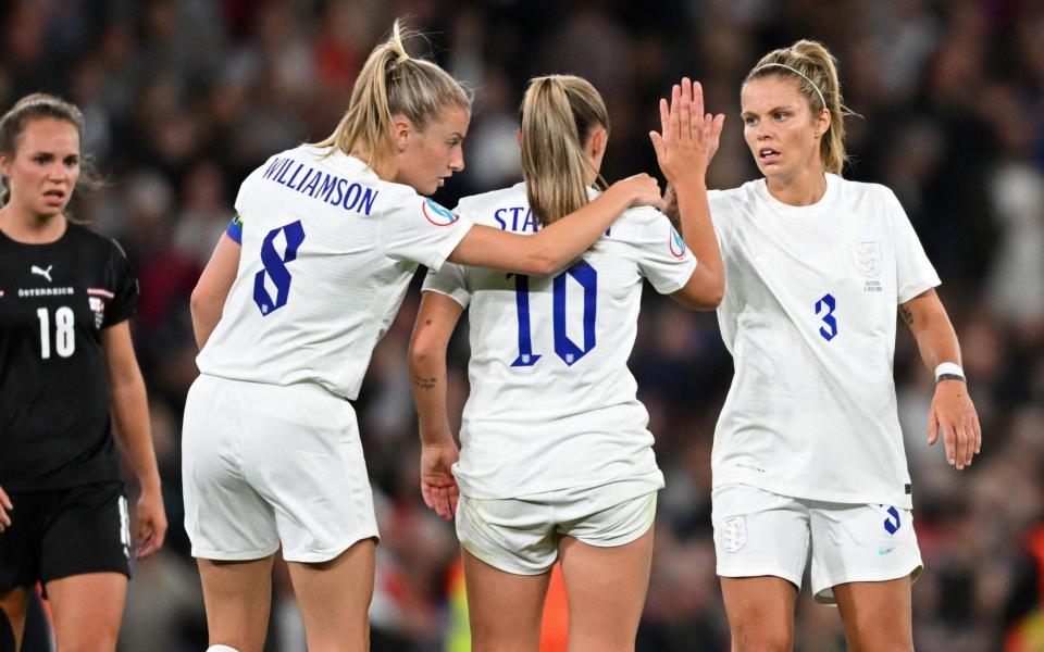 England's midfielder Leah Williamson (L), England's midfielder Georgia Stanway (C) and England's defender Rachel Daly (R) celebrate on the final whistle in the UEFA Women's Euro 2022 Group A football match between England and Austria at Old Trafford in Manchester, north-west England on July 6, 2022. - England won the game 1-0. - Daniel Mihailescu/AFP