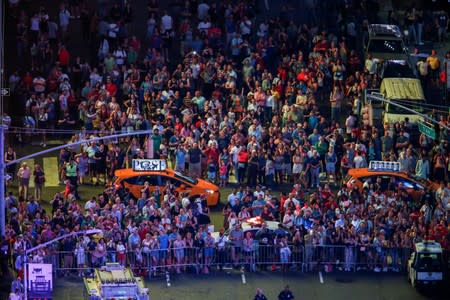 People watch Aerialist Nik Wallenda and his sister Lijana walk the highwire over Times Square in New York