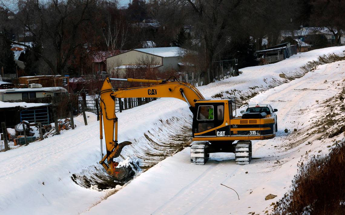 A Columbia Irrigation District employee uses a track hoe to scrape buildup from the walls of their canal on a snowy December morning near the Benton County Fairgrounds in Kennewick. With frigid winter temperatures gripping the Mid-Columbia region, the late March start of irrigation season seems far away but annual maintenance and improvements are needed during the off-season.