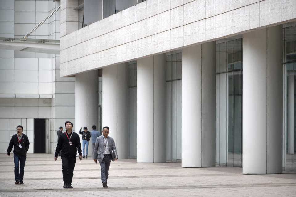 Employees walk through Huawei's campus in Shenzhen in southern China's Guandong Province, Thursday, Dec. 5, 2019. Chinese tech giant Huawei is asking a U.S. federal court to throw out a rule that bars rural phone carriers from using government money to purchase its equipment on security grounds. (AP Photo/Mark Schiefelbein)