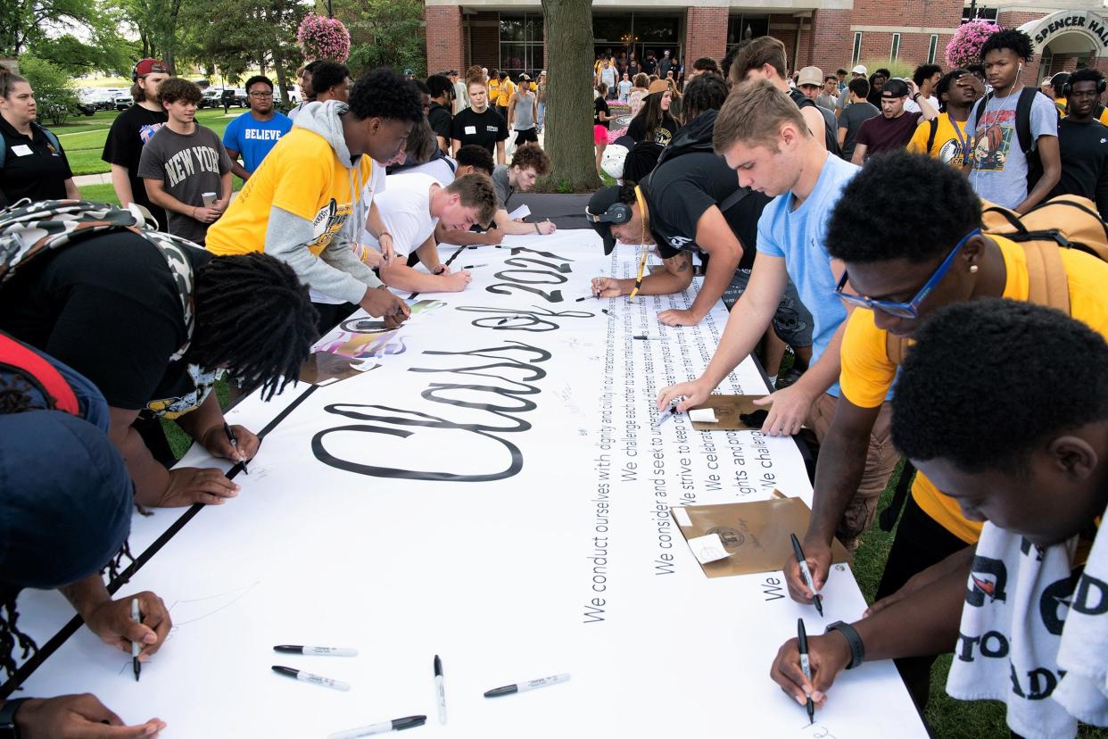 Incoming Adrian College students are pictured Aug. 13 signing the Class of 2027 banner to solidify their commitment to Adrian College's student code of conduct and community standards during the college's Welcome Week slate of activities last week.