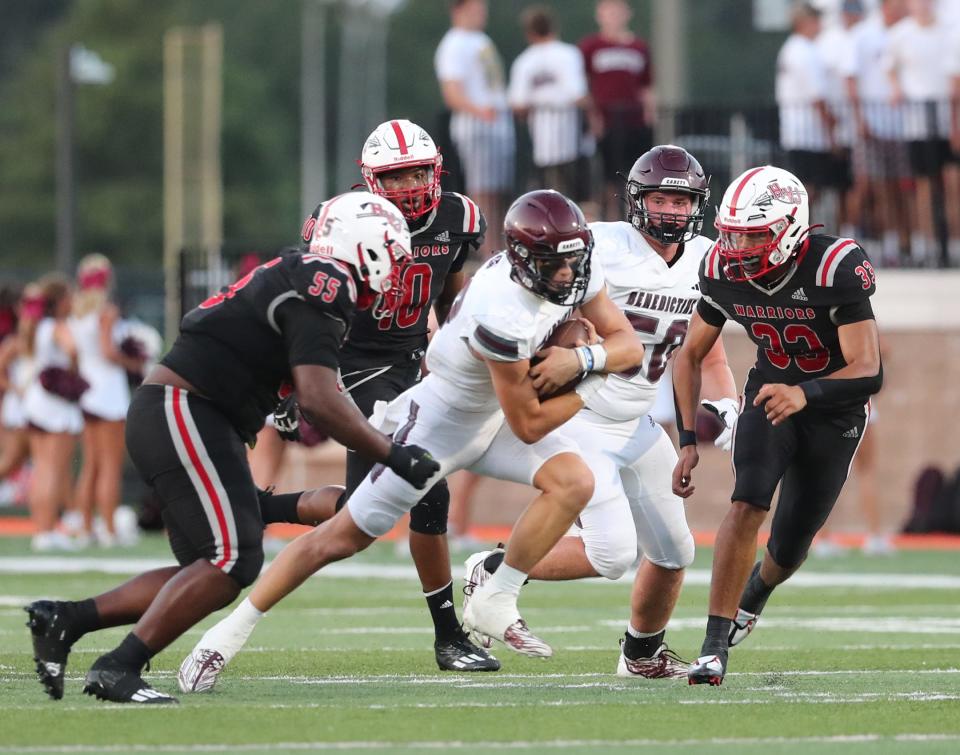 Benedictine quarterback Luke Kromenhoek protects the ball as he gains yardage against the Jenkins defense during the season opener on Friday, August 18, 2023.