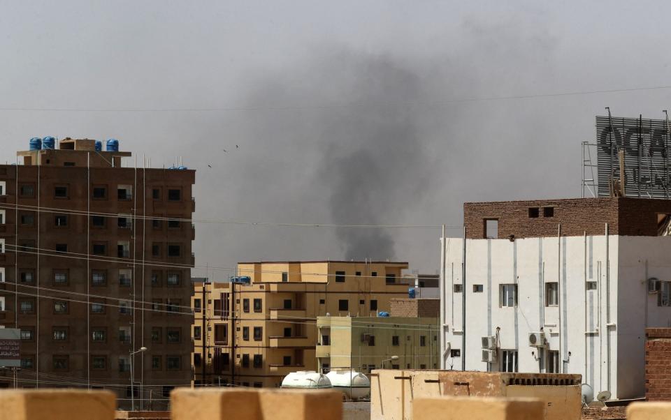 Smoke rises above buildings in Khartoum amid reported clashes in the city - AFP