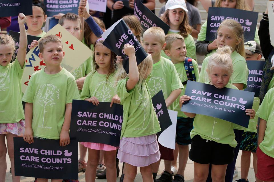 Children from Growing Tree Child Care Center in New Glarus, Wis. have a variety of expressions during an event on the steps at the Wisconsin State Capitol, Thursday, June 15, 2023, in Madison, Wis. The children were with their day care leaders to highlight the possible funding lapse for child care.