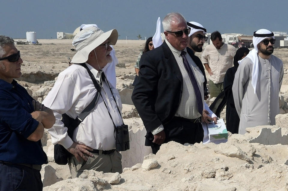 FILE - Peter Hellyer, second left, visits an ancient Christian monastery on Siniyah Island in Umm al-Quwain, United Arab Emirates, Thursday, Nov. 3, 2022. Hellyer, a British born writer with wide-ranging interests who spent nearly five decades chronicling the history, natural beauty and modern transformation of the United Arab Emirates, has died at the age of 75, local media reported Monday, July 3, 2023. (AP Photo/Kamran Jebreili, File)