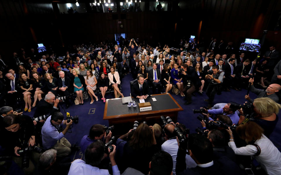 Supreme Court nominee Brett Kavanaugh is surrounded by photographers as he takes his seat for his Senate Judiciary Committee confirmation hearing on Capitol Hill in Washington, D.C., on Tuesday. (Jim Bourg/Reuters)