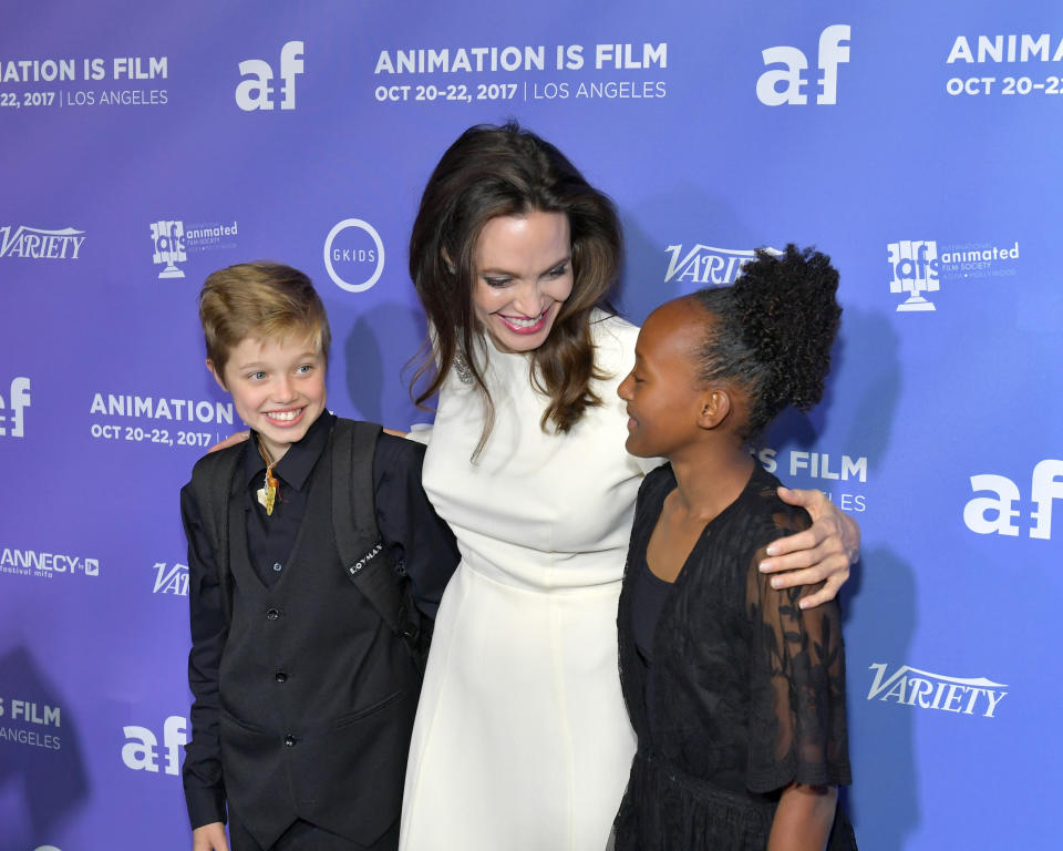 <p>Here are Angelina, Shiloh, and Zahara at the premiere of The Breadwinner in Hollywood on Oct. 20. She was executive producer of the film, which is about a headstrong girl in Afghanistan who disguises herself as a boy in order to provide for her family. (Photo: Neilson Barnard/Getty Images) </p>